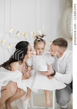 Family celebrating young girl's second birthday together 118861441