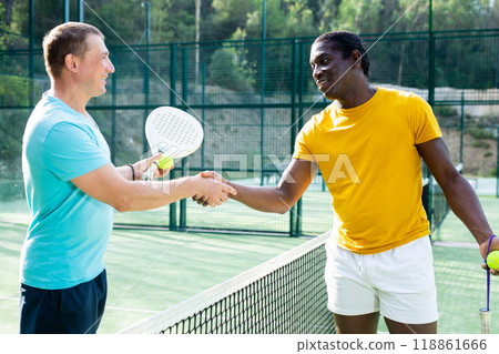 Men handshaking after padel tennis match outdoors 118861666