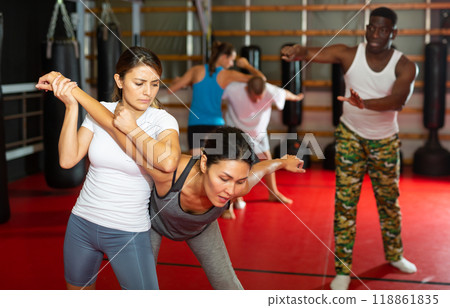 Women exercising during group self-defense training Women exercising during group self-defense training 118861835