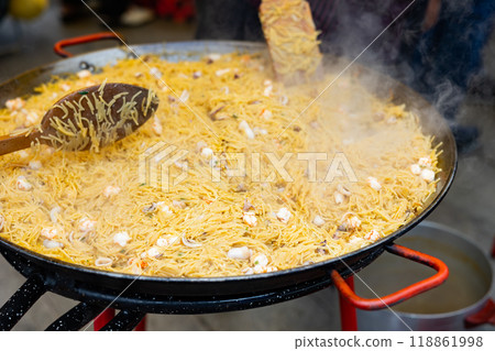 Cooking the Valencian dish Fideua de Marisco 118861998