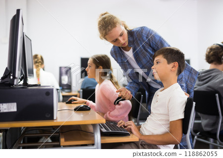 Girl helping boy with computer problem Girl helping boy with computer problem 118862055