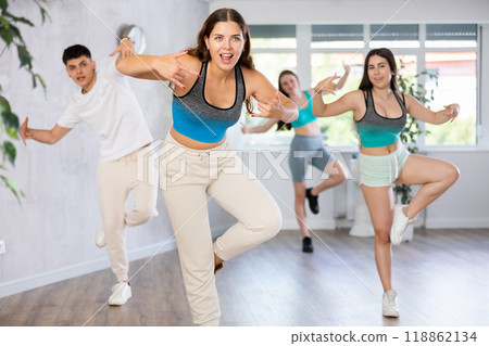 Young girl practicing hip-hop movements during group dance class Young girl practicing hip-hop movements during group dance class 118862134
