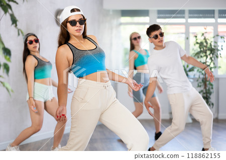 Young girl krumper dancing with group of teenagers in studio 118862155