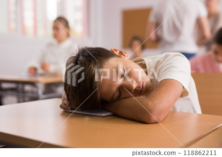 Young boy sleeping during lesson Young boy sleeping during lesson 118862211