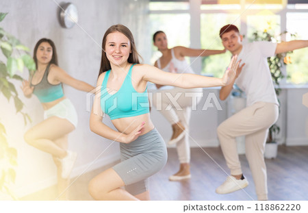 Girl teen perform choreographic exercise and teach energetic waacking dance with friends 118862220