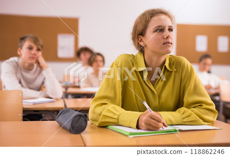 Teenage girl in classroom during lesson in school 118862246