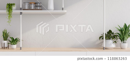 A close-up a minimalist wooden table against a white wall, featuring decorative plants. A close-up a minimalist wooden table against a white wall, featuring decorative plants. 118863263