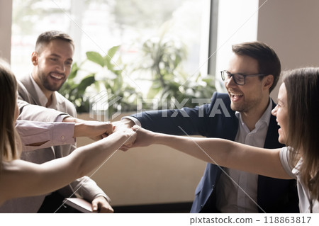 Cheerful happy office friends making fist bump group gesture 118863817