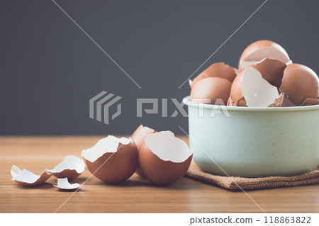 Pile of eggshells sits on a table against a gray background, symbolizing the potential benefits of eggshells in sustainability, from gardening and composting to household uses. Pile of eggshells sits on a table against a gray background, symbolizing the potential benefits of eggshells in sustainability, from gardening and composting to household uses. 118863822