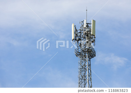 A cellphone tower stands tall against the sky, its structure silhouetted by the vast blue backdrop. The image captures the intersection of technology and the natural world. 118863823