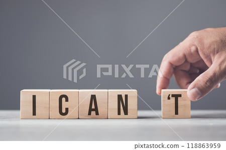 A hand separates the letter "T" from the word "can't," transforming it into "can." The image symbolizes overcoming obstacles, shifting from doubt to empowerment, and embracing a positive mindset. A hand separates the letter "T" from the word "can't," transforming it into "can." The image symbolizes overcoming obstacles, shifting from doubt to empowerment, and embracing a positive mindset. 118863959