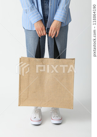 A woman holds a bag on a white background 118864190