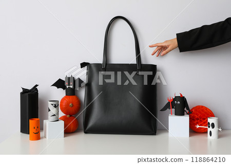 Black bag with Halloween decorations on a white background 118864210