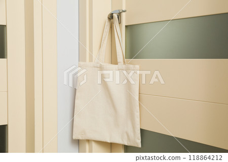 The bag hangs on the doorknob in the room 118864212