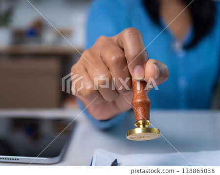Approval stamp, Signing on business partner paper to success, Businesswoman hand stamping with approved stamp on text approved document at desk, Validates and manages business documents and 118865038