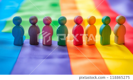 Wooden figurines symbolizing people form a bond against the background of a rainbow flag Wooden figurines symbolizing people form a bond against the background of a rainbow flag 118865275