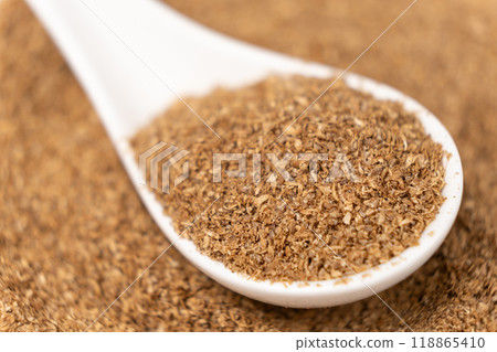 Ground coriander natural spice in a spoon close-up. Ground coriander natural spice in a spoon close-up. 118865410