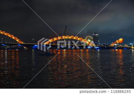 A famous landmark is the Dragon Bridge or Cau Rong over Han River in Da Nang in Vietnam at night with a golden illumination 118866293