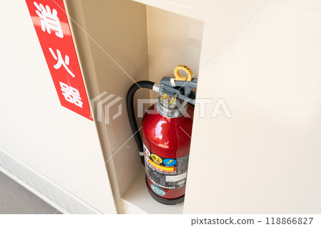 A fire extinguisher installed in the apartment hallway A fire extinguisher installed in the apartment hallway 118866827