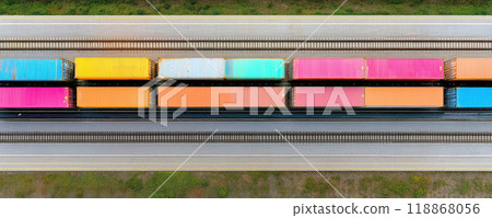 Colorful train containers are lined up along railway, showcasing vibrant array of hues including pink, orange, and blue. This striking visual captures essence of transportation and logistics 118868056