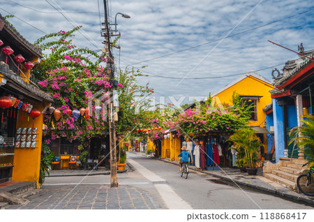 Beautiful streets with traditional ancient yellow houses and buildings in old town in Hoi An city in Vietnam in summer at day Beautiful streets with traditional ancient yellow houses and buildings in old town in Hoi An city in Vietnam in summer at day 118868417
