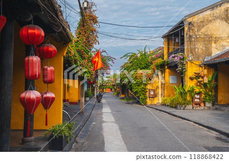 Streets with traditional ancient yellow houses in old town in Hoi An city in Vietnam at summer day 118868422
