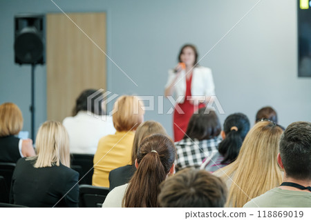 Woman giving a presentation to a business audience Woman giving a presentation to a business audience 118869019