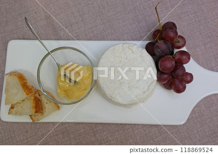fresh ricotta cheese with linden white light honey Fresh homemade dairy ricotta cheese, close-up opening white net bag fresh ricotta cheese with linden white light honey Fresh homemade dairy ricotta cheese, close-up opening white net bag 118869524
