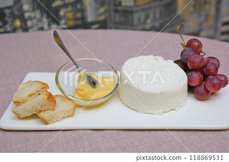 fresh ricotta cheese with linden white light honey Fresh homemade dairy ricotta cheese, close-up opening white net bag fresh ricotta cheese with linden white light honey Fresh homemade dairy ricotta cheese, close-up opening white net bag 118869531
