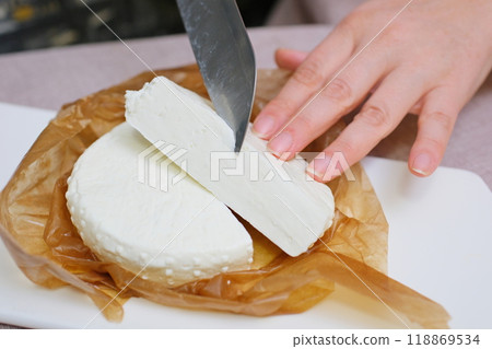 fresh ricotta cheese with linden white light honey Fresh homemade dairy ricotta cheese, close-up opening white net bag fresh ricotta cheese with linden white light honey Fresh homemade dairy ricotta cheese, close-up opening white net bag 118869534