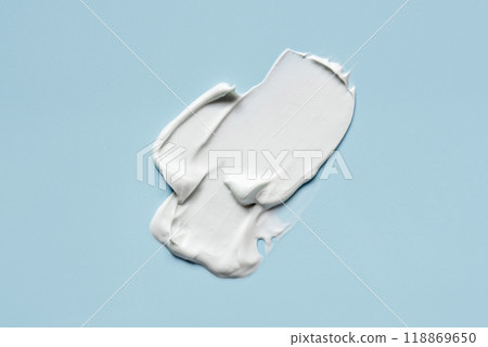 Smear of cream on a blue background. Smear of cream on a blue background. 118869650