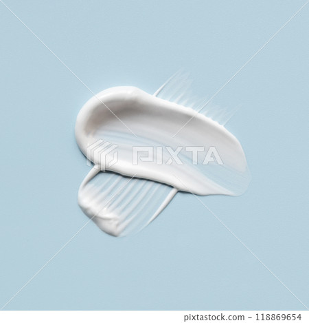 Smear of cream on a blue background. Smear of cream on a blue background. 118869654