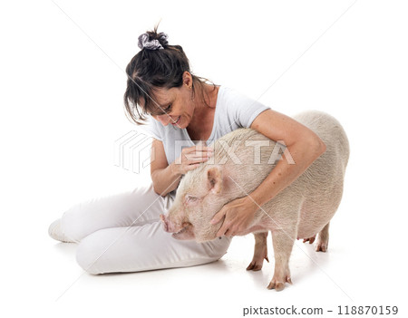 miniature pig and woman in studio 118870159