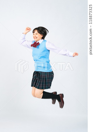Full-body photo of a female student in uniform jumping 118873325