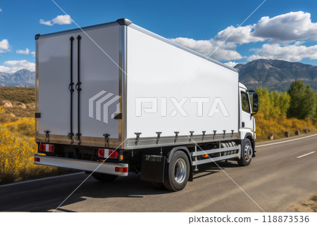 A white truck is driving on the road against the background of a summer landscape 118873536