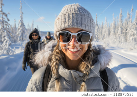 Portrait of a girl in the winter outdoors, traveling with a group of tourists through the forest Portrait of a girl in the winter outdoors, traveling with a group of tourists through the forest 118873555