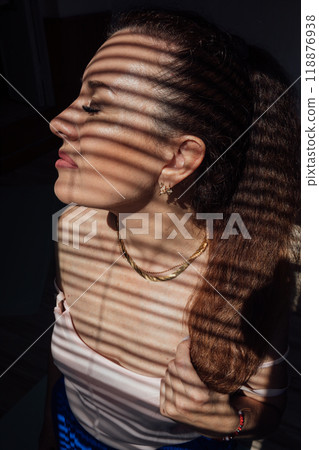 Beautiful brunette woman and blind light and shadow 118876938