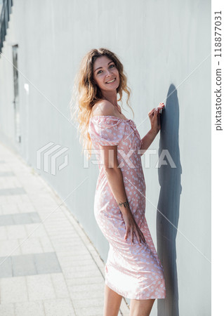 Beautiful blonde woman smiling in summer dress on a walk 118877031