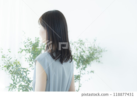 Young woman in a light blue dress Young woman in a light blue dress 118877431