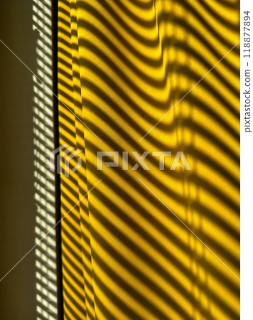 Yellow curtains with beautiful shade from blinds on a sunny day. Abstract background. 118877894
