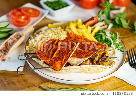 Close up of Middle Eastern Arab meal with fried potato, falafel, hummus, vegetables salad Close up of Middle Eastern Arab meal with fried potato, falafel, hummus, vegetables salad 118878138