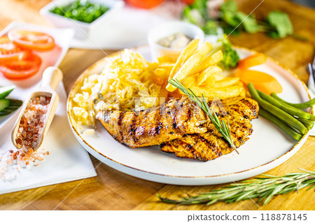 Fried Wiener schnitzel from veal topside with French fries as top view on a modern design plate with copy space Fried Wiener schnitzel from veal topside with French fries as top view on a modern design plate with copy space 118878145
