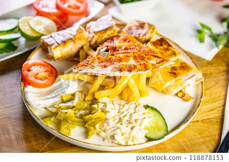 Chicken roll breast stuffed with butter, garlic and dill. Served with baked potato slices and fresh herbs. 118878153