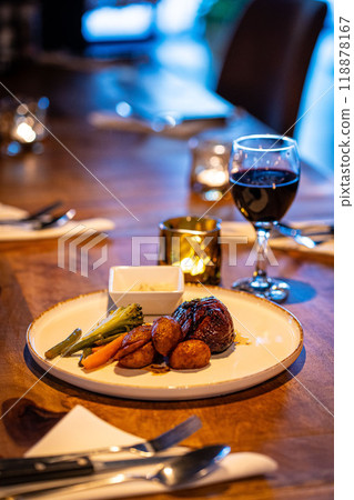 Beef steak meat with vegetables and sauce served with red wine and candles 118878167