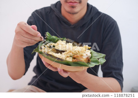 man eating grilled rice from a plate man eating grilled rice from a plate 118878251