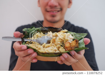man eating grilled rice from a plate man eating grilled rice from a plate 118878252