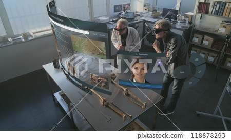 Two archaeologists in VR headsets study skeleton remains using augmented reality Two archaeologists in VR headsets study skeleton remains using augmented reality 118878293