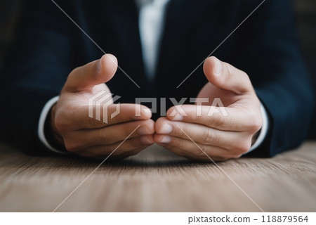Finding Peace: A businessman finds solace and clarity through prayer at her desk, her open hands reflecting a moment of quiet reflection amidst the demands of her workday. Finding Peace: A businessman finds solace and clarity through prayer at her desk, her open hands reflecting a moment of quiet reflection amidst the demands of her workday. 118879564