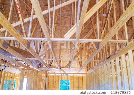 Silver insulation ventilation pipes installing on ceiling attic during construction home 118879825