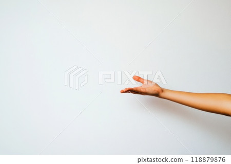 A hand reaching out against a plain background in a bright well lit setting symbolizing invitation or connection 118879876